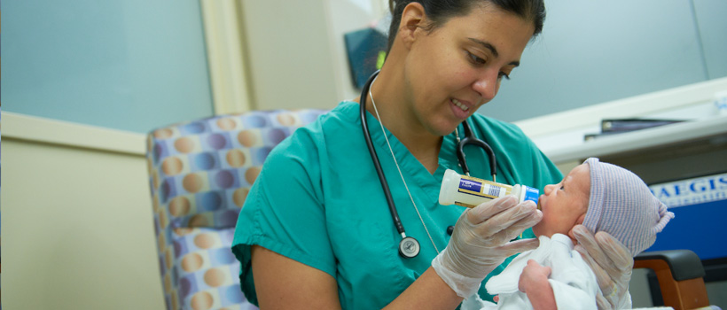 Neonatal nurse with infant
