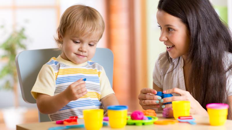 Child and mother playing with modeling clay.