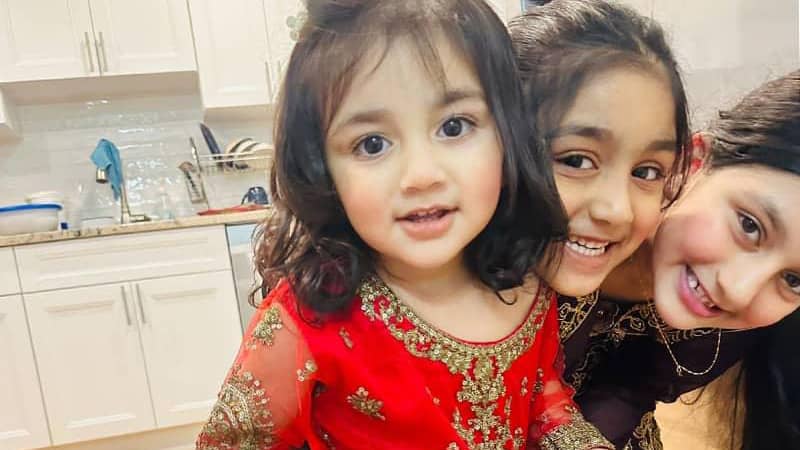 Parrizay and her two siblings smiling.